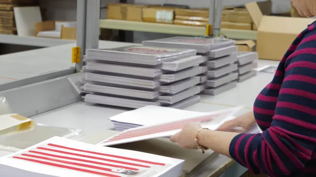 A woman packing posters