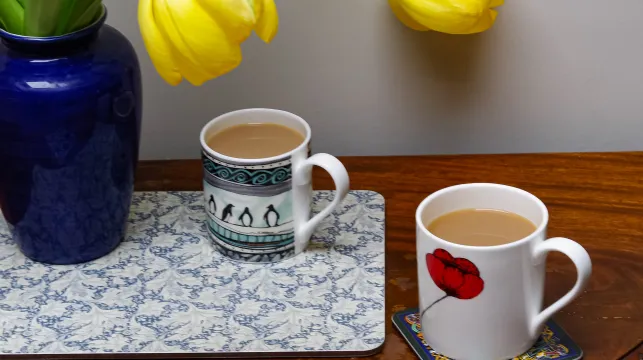 tulips and mugs of tea on coasters