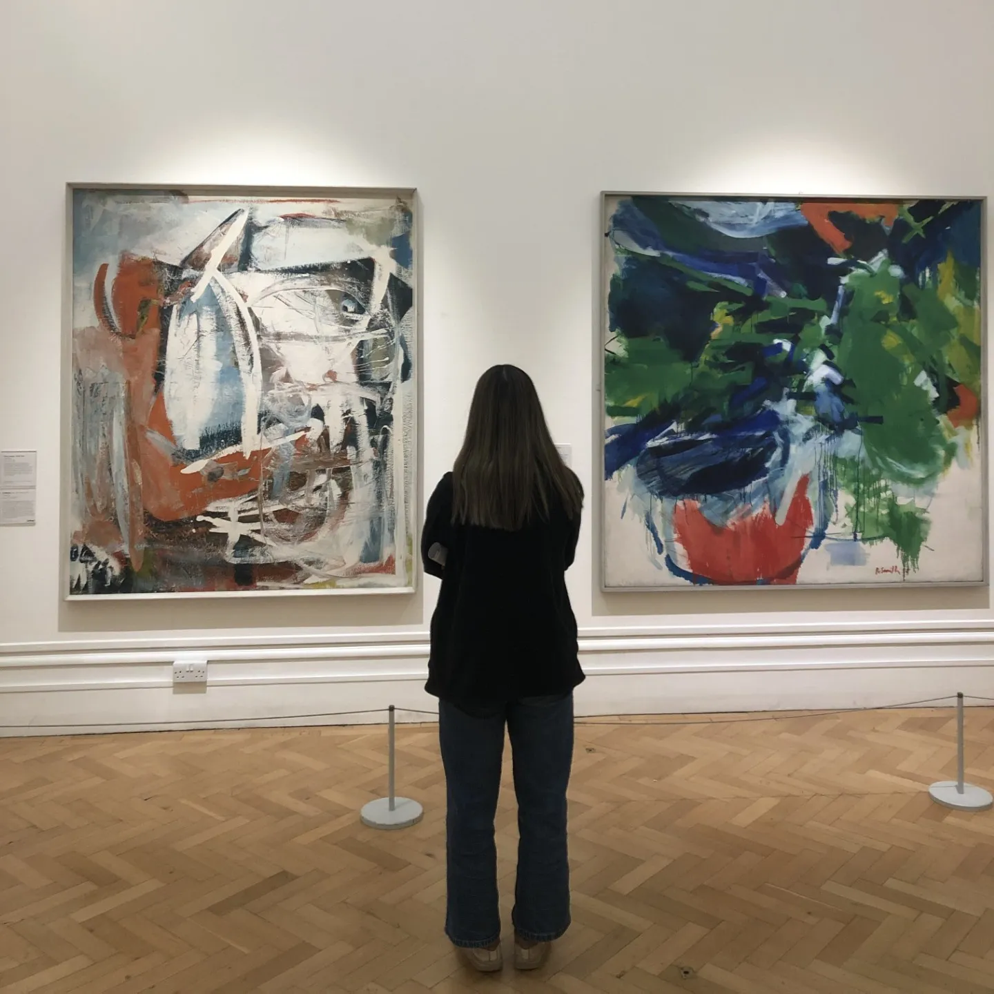 Woman looking at museum paintings